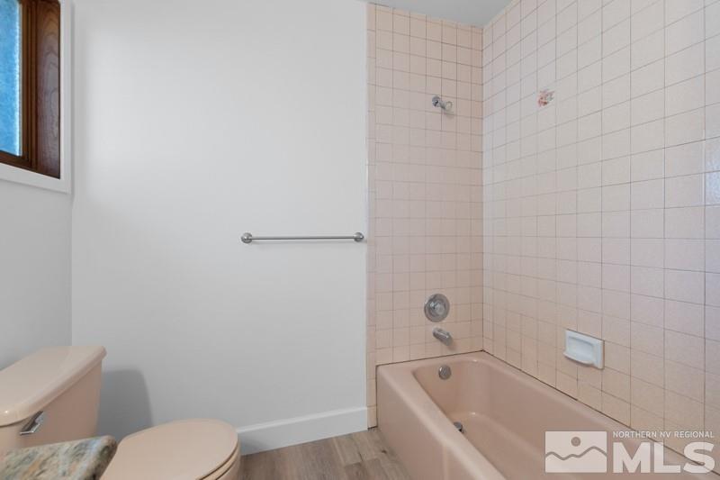 7270 Pembroke Drive Reno, NV 89502 - Photo 17 of 38 a bathroom with a toilet and bathtub