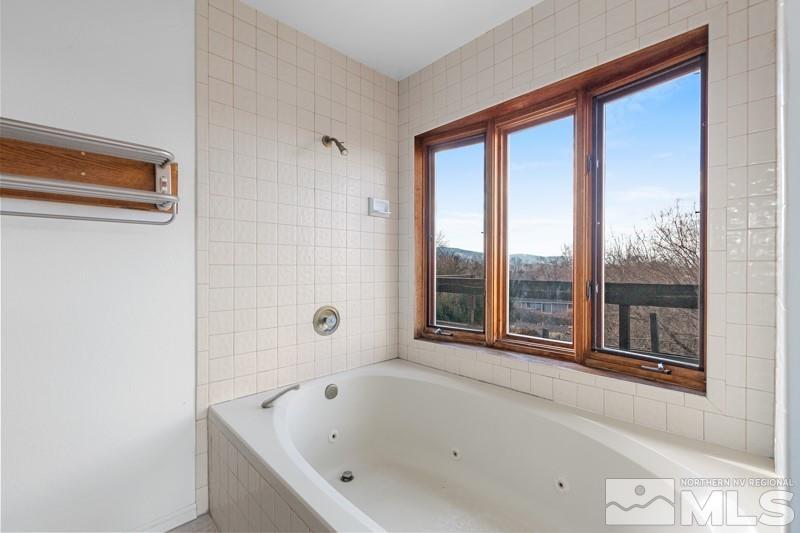 7270 Pembroke Drive Reno, NV 89502 - Photo 23 of 38 a bathroom with a bathtub and next to a window