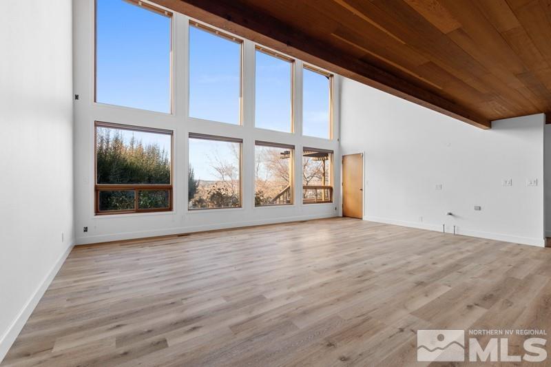 7270 Pembroke Drive Reno, NV 89502 - Photo 3 of 38 a view of an empty room with wooden floor and a window