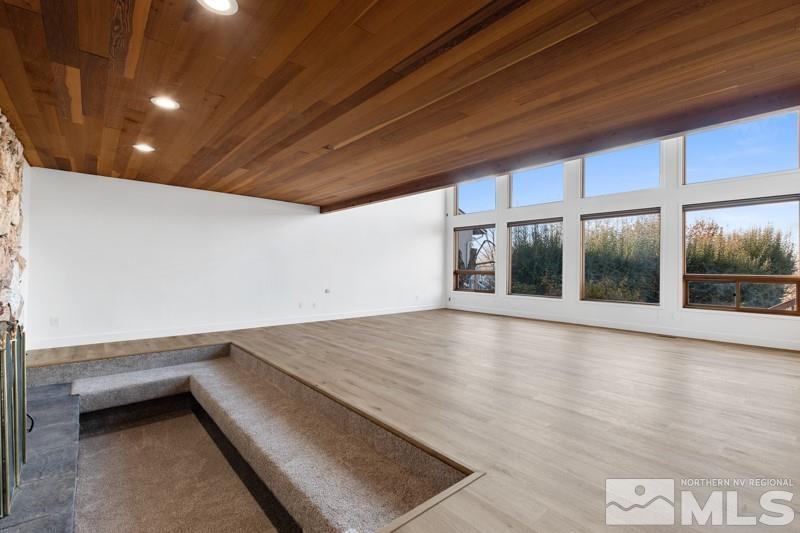 7270 Pembroke Drive Reno, NV 89502 - Photo 4 of 38 a view of an empty room with wooden floor and a window