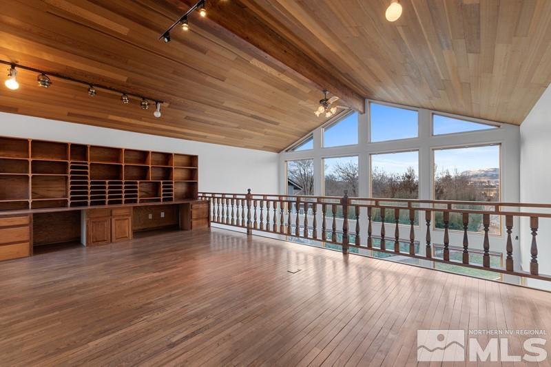 7270 Pembroke Drive Reno, NV 89502 - Photo 8 of 38 an empty room with wooden floor and windows