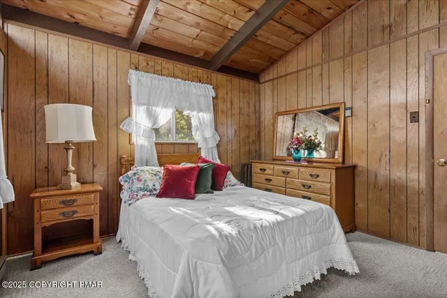 a bedroom with a bed and a mirror