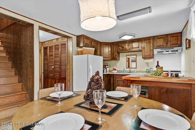 a kitchen with stainless steel appliances granite countertop a stove top oven a sink dishwasher and cabinets with wooden floor