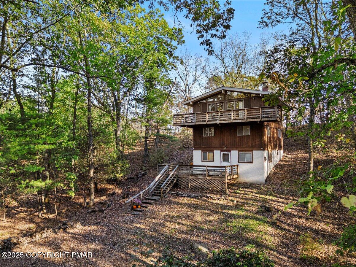 652 Rimrock Road Bartonsville, PA 18321 - Photo 2 of 37 a view of a chair and table on the wooden deck