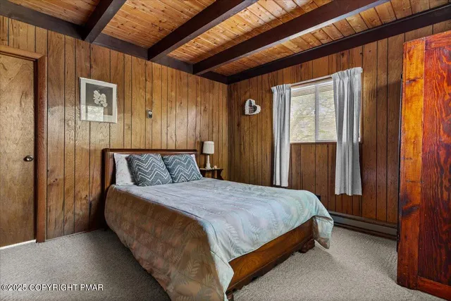 a bed sitting in a spacious bedroom next to a window