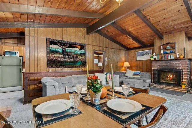 a living room with furniture a fireplace and a table