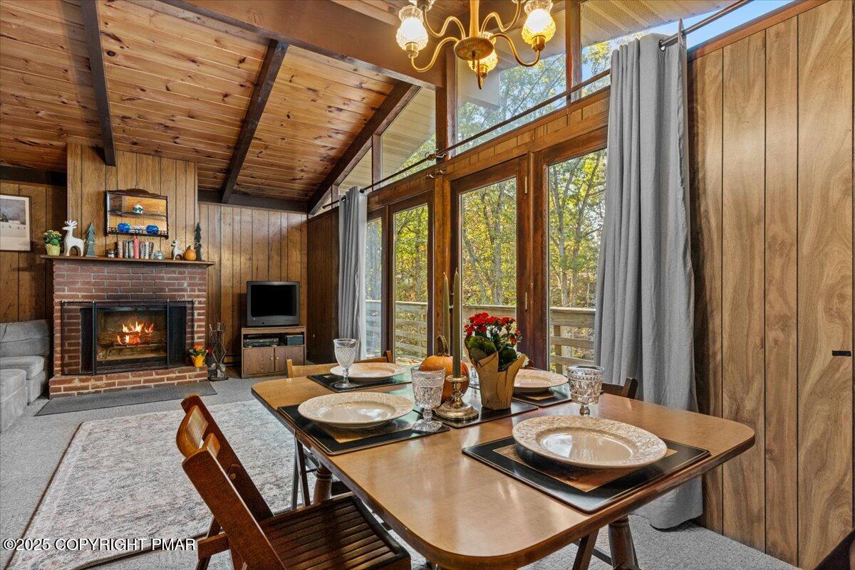 652 Rimrock Road Bartonsville, PA 18321 - Photo 7 of 37 a dining room with furniture a fireplace and large windows