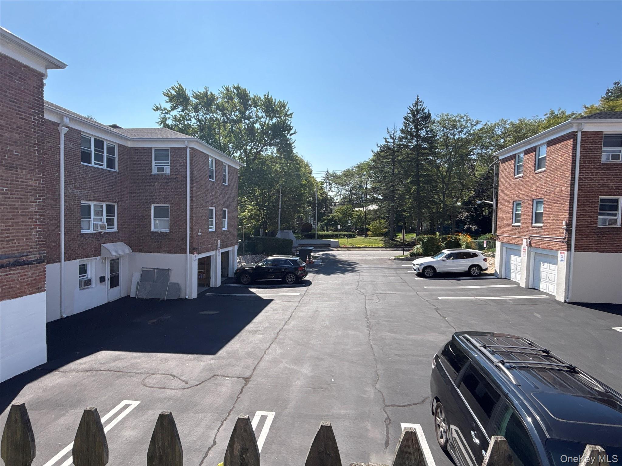 37 Spruce Street, Unit 2 Great Neck, NY 11021 - Photo 12 of 18 a view of city street with a car parked on the road