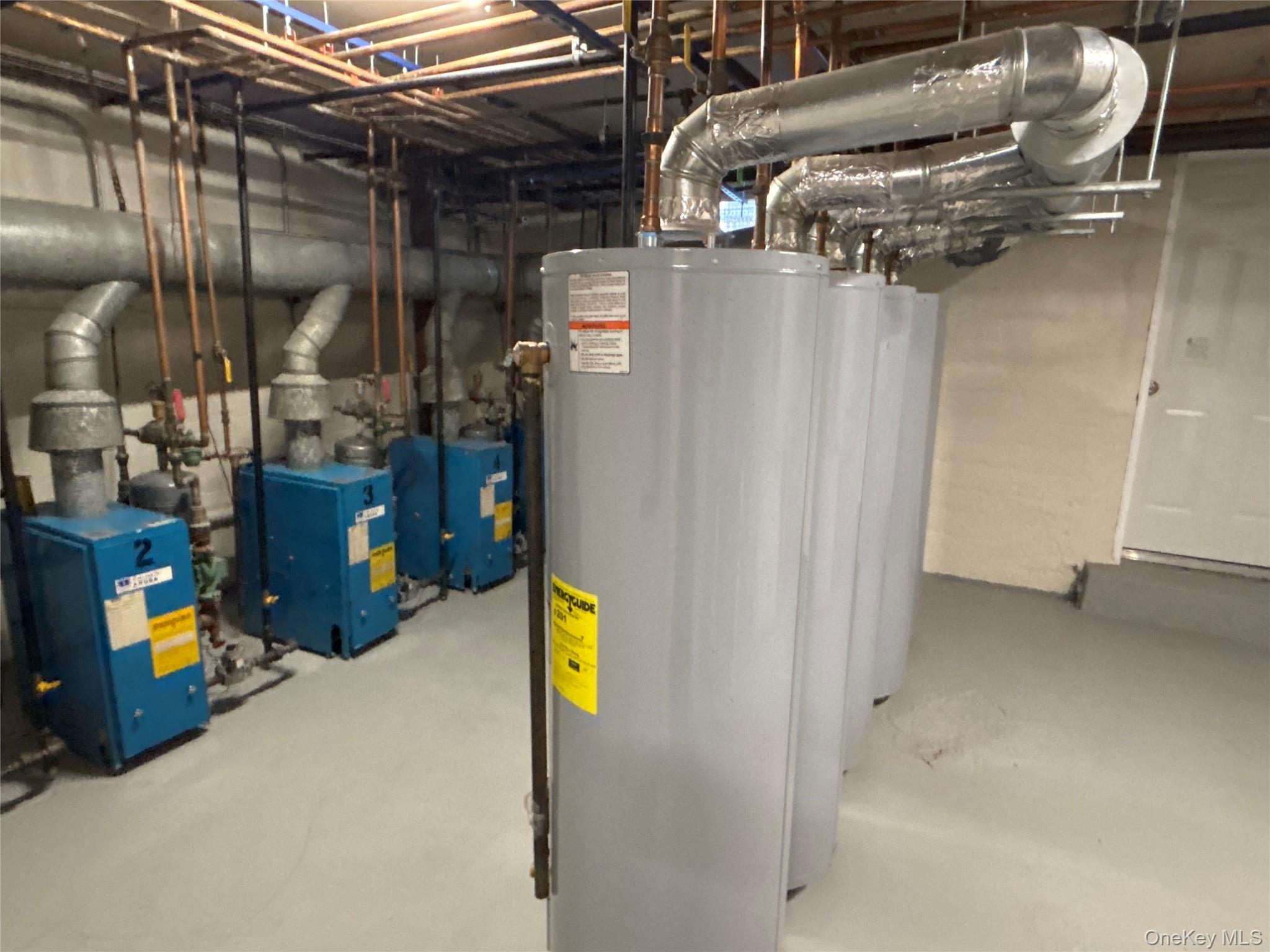 37 Spruce Street, Unit 2 Great Neck, NY 11021 - Photo 17 of 18 a utility room with dryer and washer