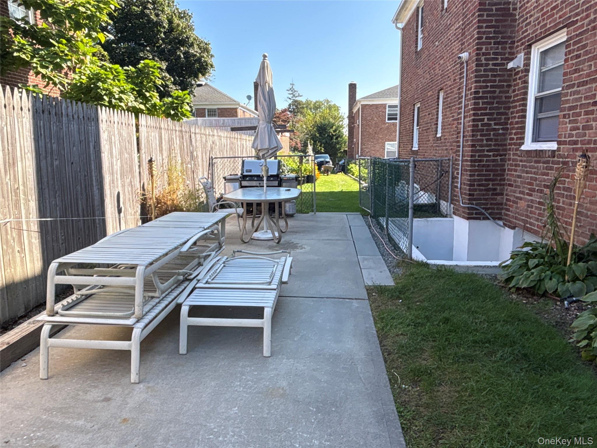 37 Spruce Street, Unit 2 Great Neck, NY 11021 - Photo 10 of 18 a view of a patio with a table and chairs