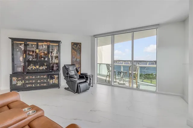 a view of kitchen with granite countertop a sink a stove and a wooden floors