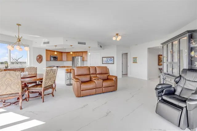 a kitchen with stainless steel appliances granite countertop a sink and a refrigerator