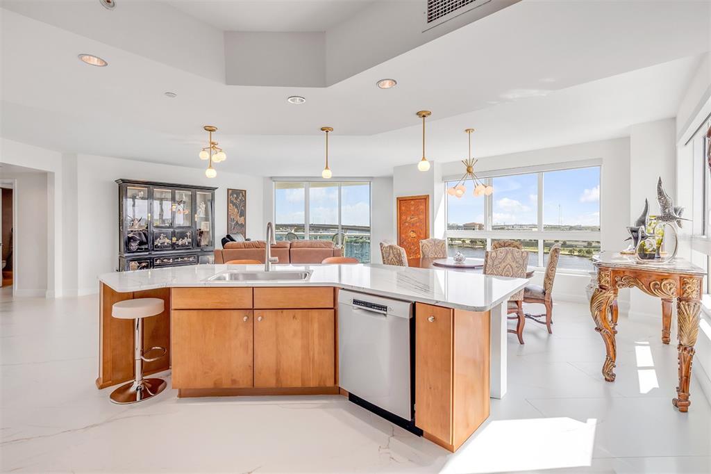 231 Riverside Drive, Unit 7091 Daytona Beach, FL 32117 - Photo 18 of 90 a kitchen with stainless steel appliances kitchen island granite countertop a table chairs sink and cabinets