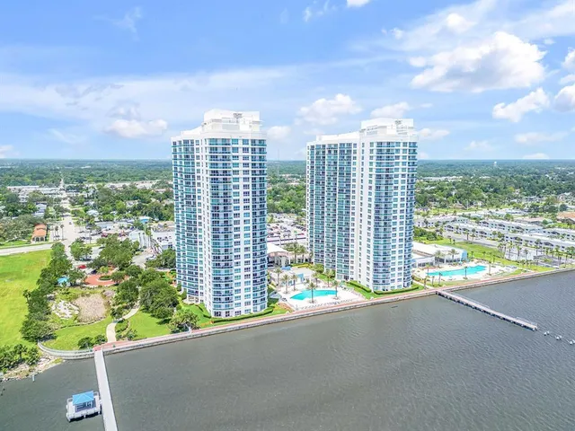 a view of a swimming pool with a patio and a garden