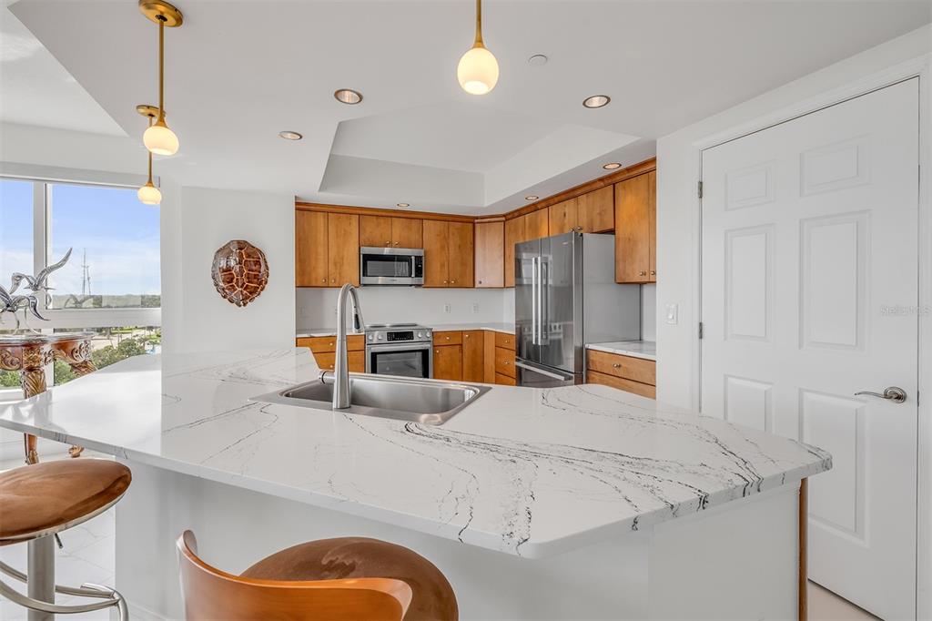 231 Riverside Drive, Unit 7091 Daytona Beach, FL 32117 - Photo 22 of 90 a kitchen with stainless steel appliances granite countertop a sink and a refrigerator