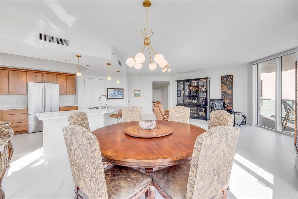 231 Riverside Drive, Unit 7091 Daytona Beach, FL 32117 - Photo 26 of 90 a dining room with furniture a rug a fireplace and a chandelier