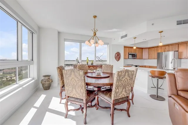 a white toilet sitting next to a white sink and vanity