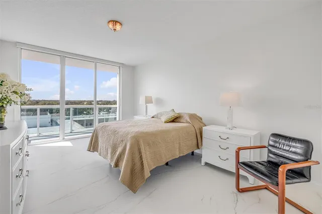 a bedroom with a bed and a flat tv screen on the dresser