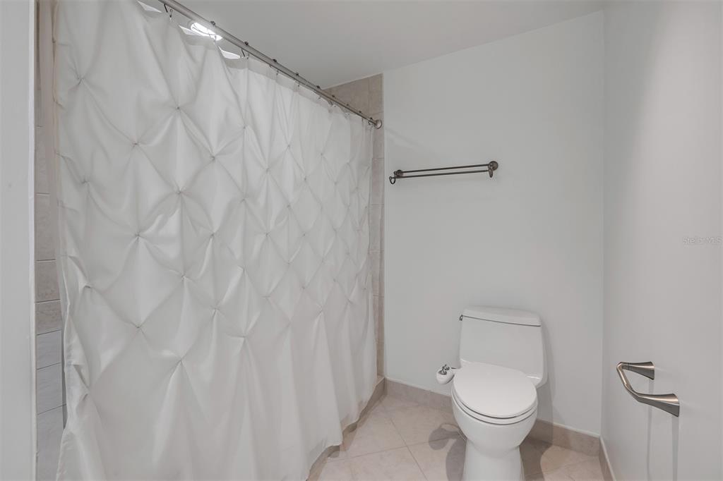 231 Riverside Drive, Unit 7091 Daytona Beach, FL 32117 - Photo 40 of 90 a white toilet sitting next to a white sink and vanity