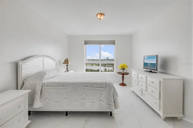 a kitchen with granite countertop a stove a sink and a refrigerator