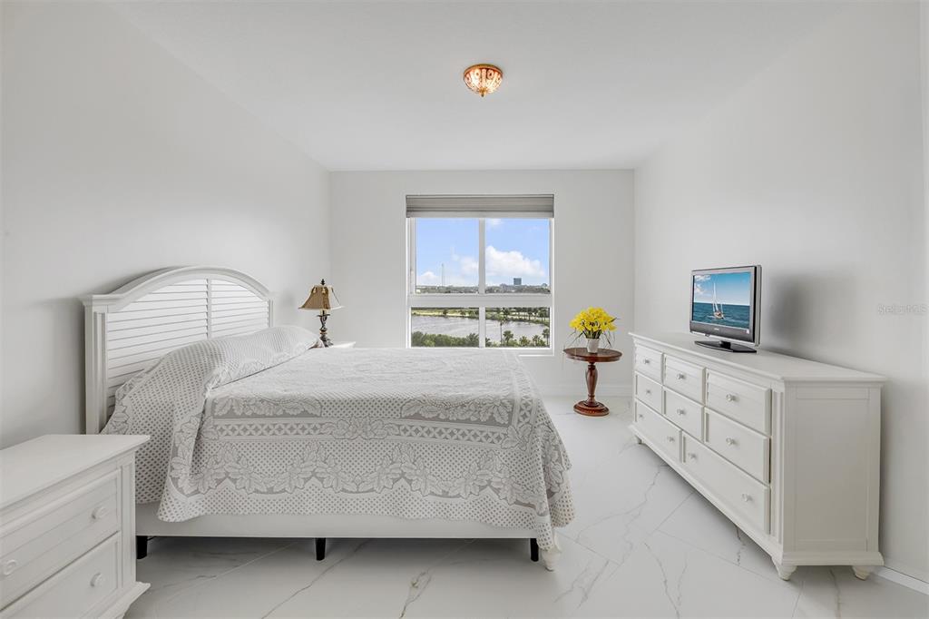 231 Riverside Drive, Unit 7091 Daytona Beach, FL 32117 - Photo 41 of 90 a bedroom with a bed and a flat tv screen on the dresser