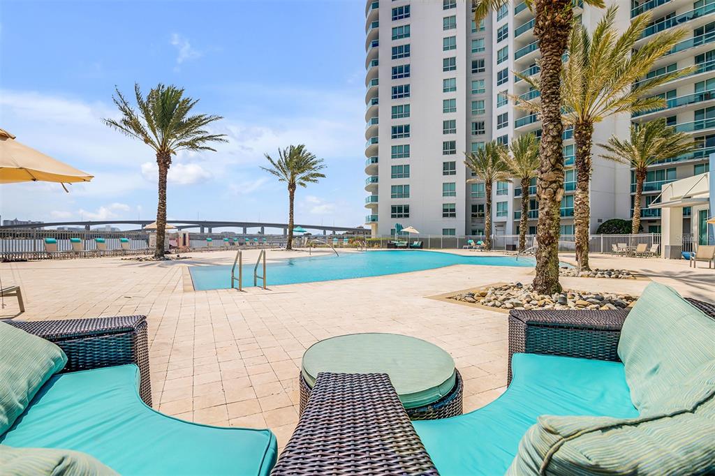 231 Riverside Drive, Unit 7091 Daytona Beach, FL 32117 - Photo 59 of 90 a view of a swimming pool with a lounge chairs