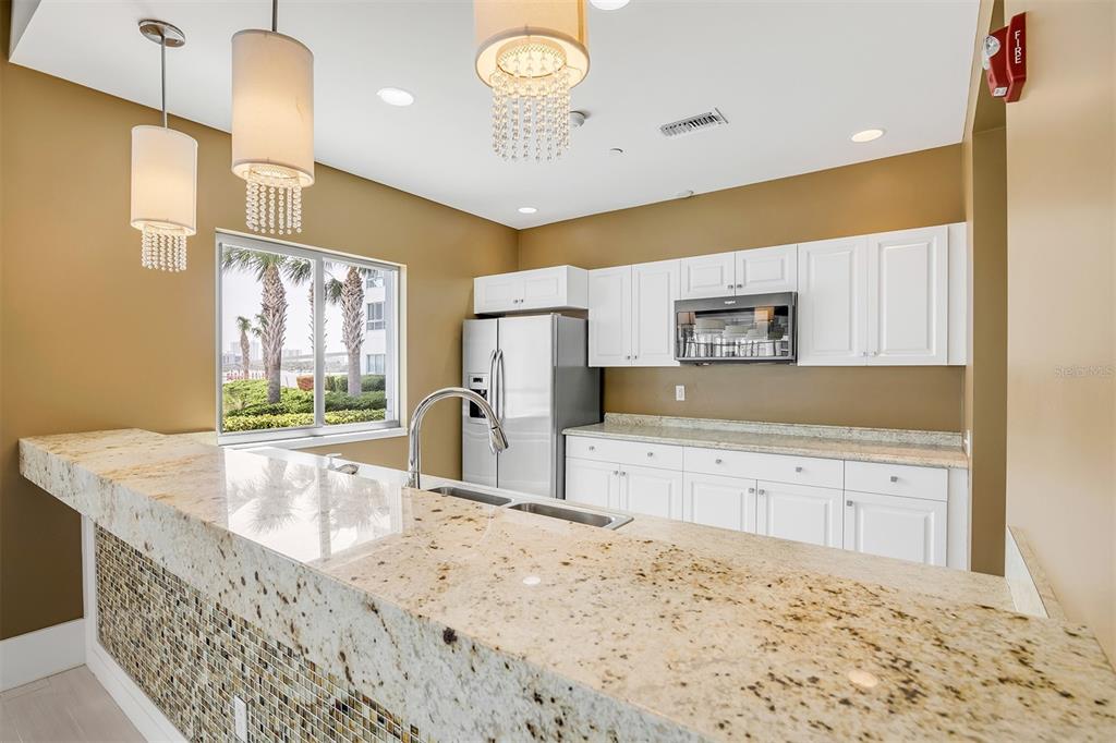 231 Riverside Drive, Unit 7091 Daytona Beach, FL 32117 - Photo 71 of 90 a kitchen with granite countertop a stove a sink and a refrigerator