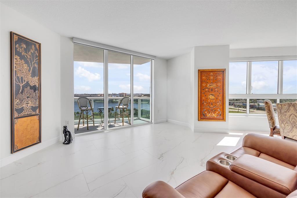 231 Riverside Drive, Unit 7091 Daytona Beach, FL 32117 - Photo 8 of 90 a living room with furniture and a floor to ceiling window