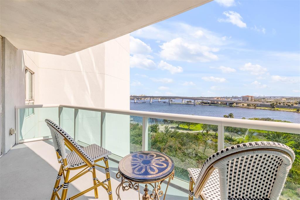 231 Riverside Drive, Unit 7091 Daytona Beach, FL 32117 - Photo 9 of 90 a view of a balcony with table and chairs