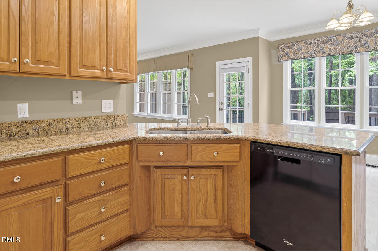 2209 Lodestar Drive Raleigh, NC 27615 - Photo 7 of 50 a kitchen with granite countertop cabinets and window