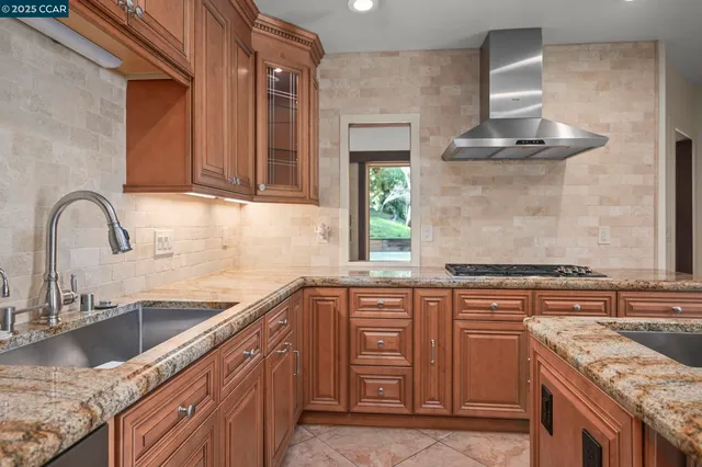 a kitchen with stainless steel appliances granite countertop a sink stove and refrigerator