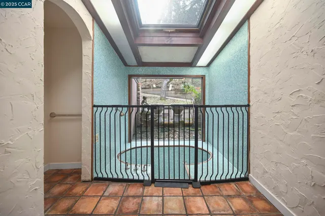 a view of an empty room with a fireplace and a window