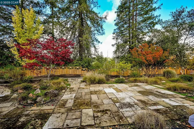 a view of a house with a yard and pathway