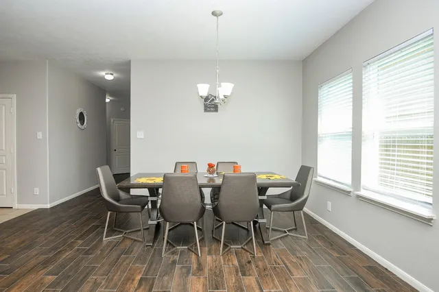 a view of a dining room with furniture and chandelier