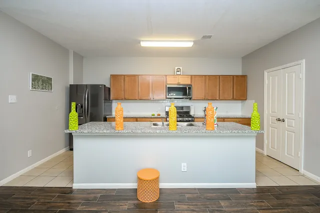 a kitchen with stainless steel appliances a sink stove and refrigerator