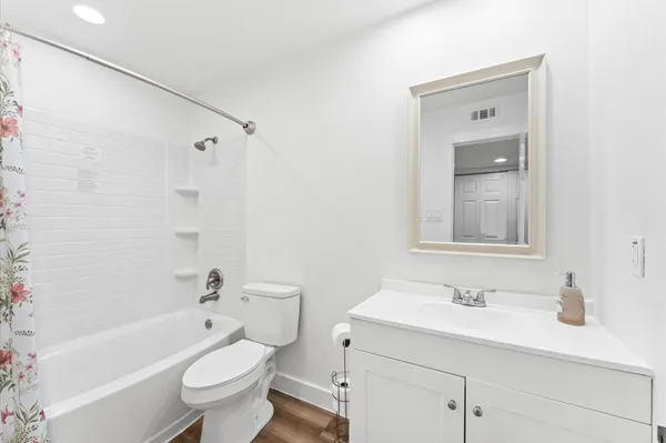 a bathroom with a sink toilet a vanity and bathtub