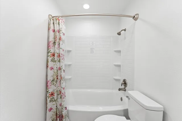 a bathroom with a bathtub and shower