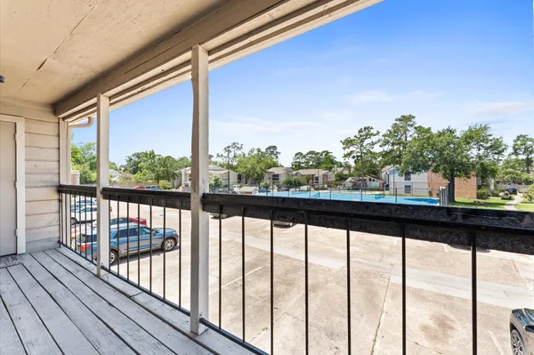 a view of balcony with wooden floor
