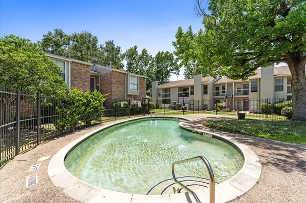 a view of a house with swimming pool and sitting area