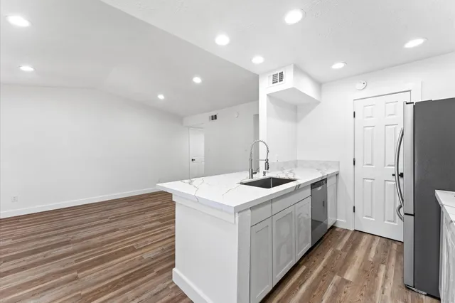 a kitchen with a sink stainless steel appliances and cabinets
