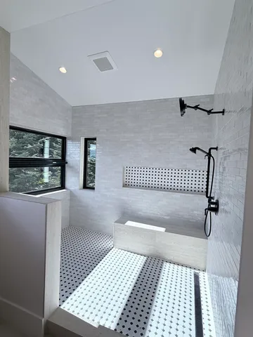 a bathroom with a bathtub and a shower