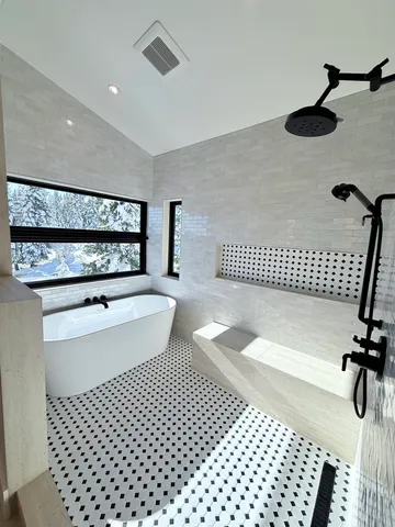 a bathroom with double vanity sinks and a mirror
