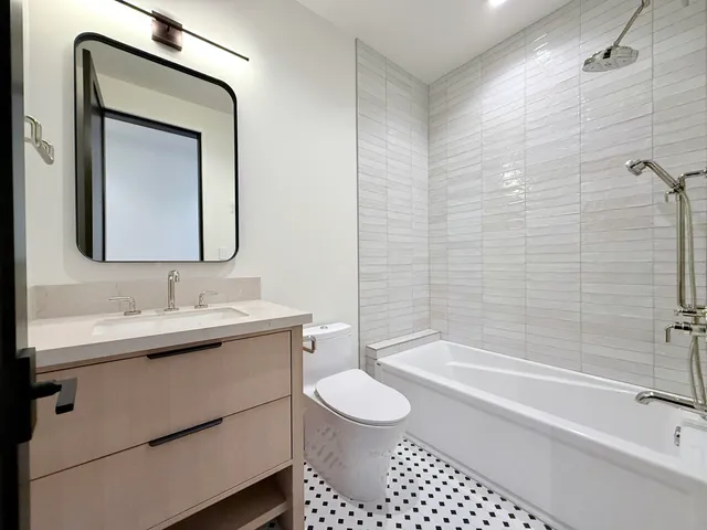 a bathroom with a sink a toilet and a shower