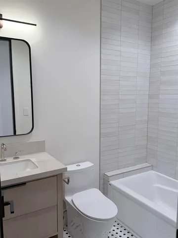 a bathroom with a sink a toilet and bathtub