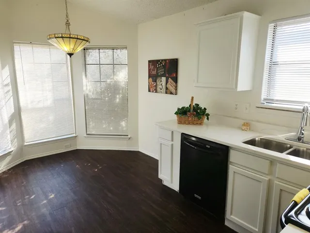a kitchen with a sink and a window