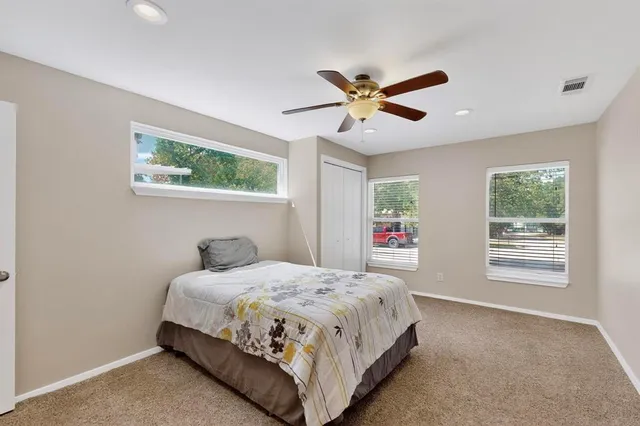 a bedroom with a large bed and a chandelier