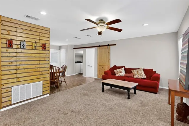 a bedroom with furniture and a ceiling fan