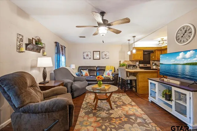 a living room with fireplace furniture and a window