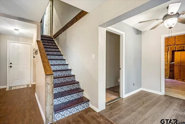 a view of a hallway with wooden floor and entryway