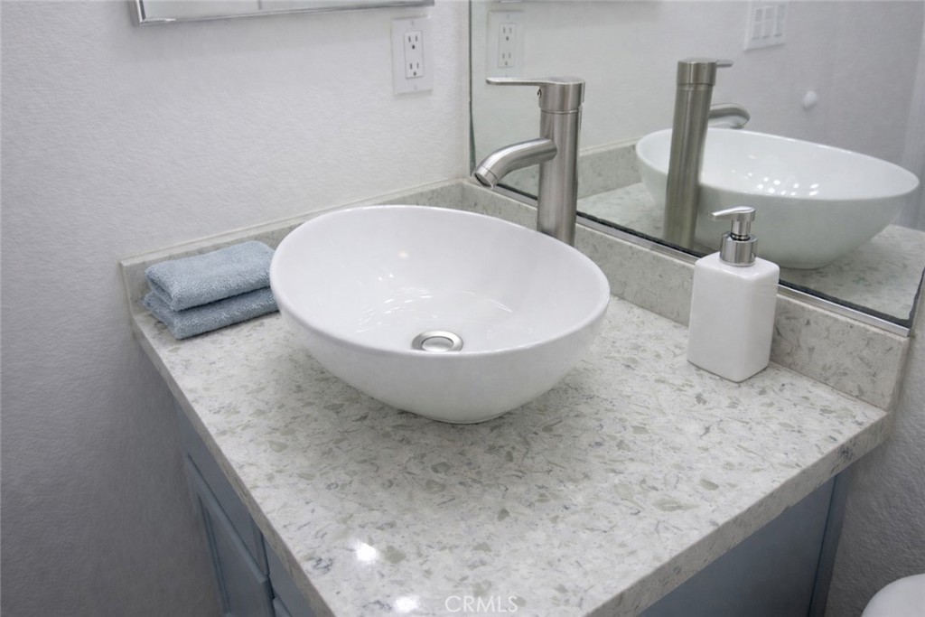 1285 Fools Gold Way, Unit 2 Chula Vista, CA 91913 - Photo 26 of 43 a view of a bathroom with a sink and mirror